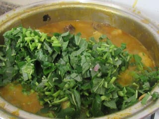 Just added green vegetables to the pot of unripe plantain porridge
